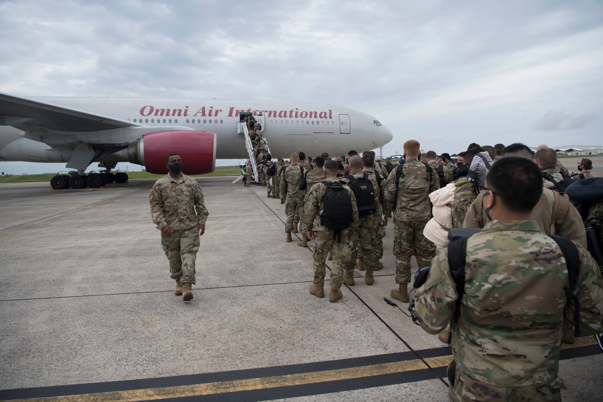Airmen board an aircraft.