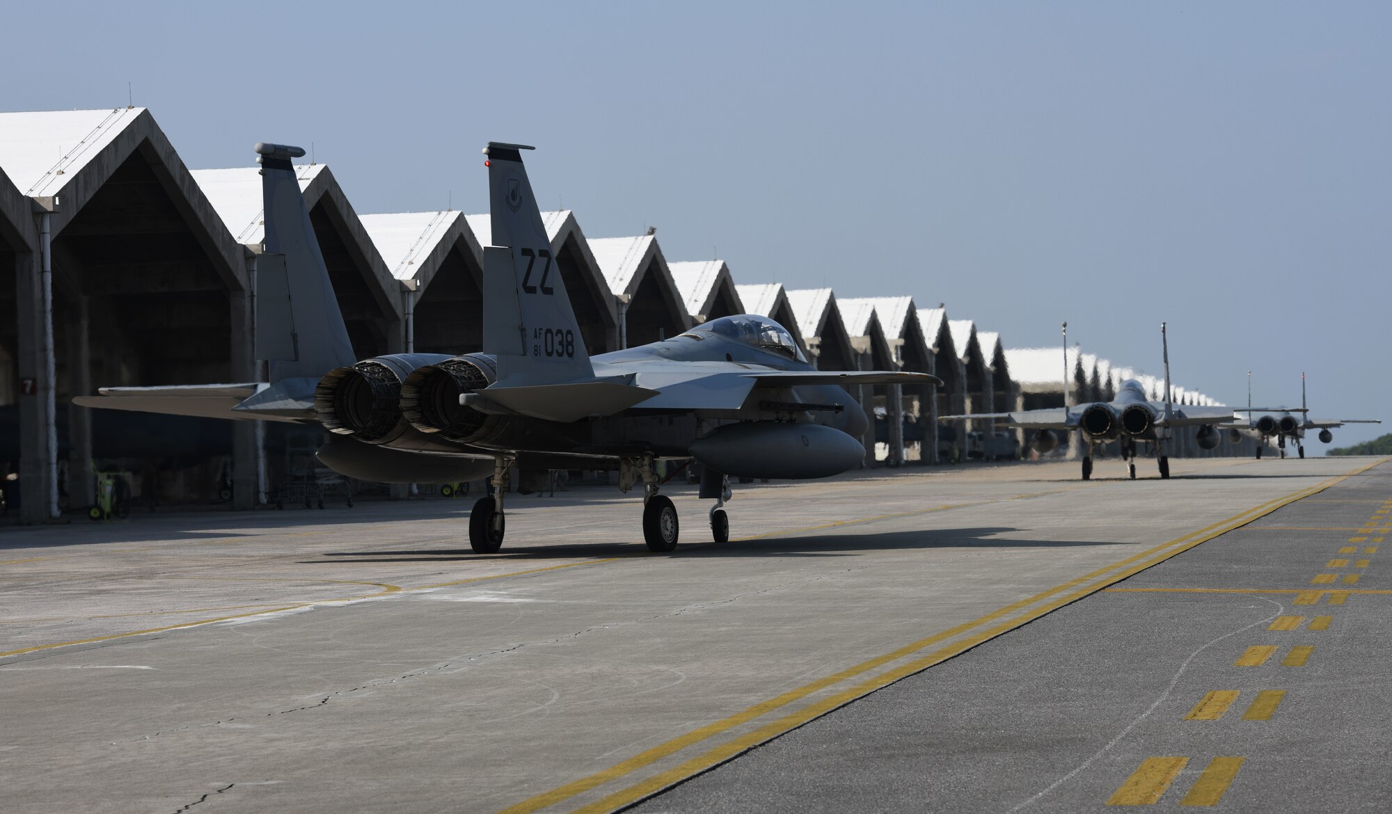 F-15C Eagles taxi along the flightline.