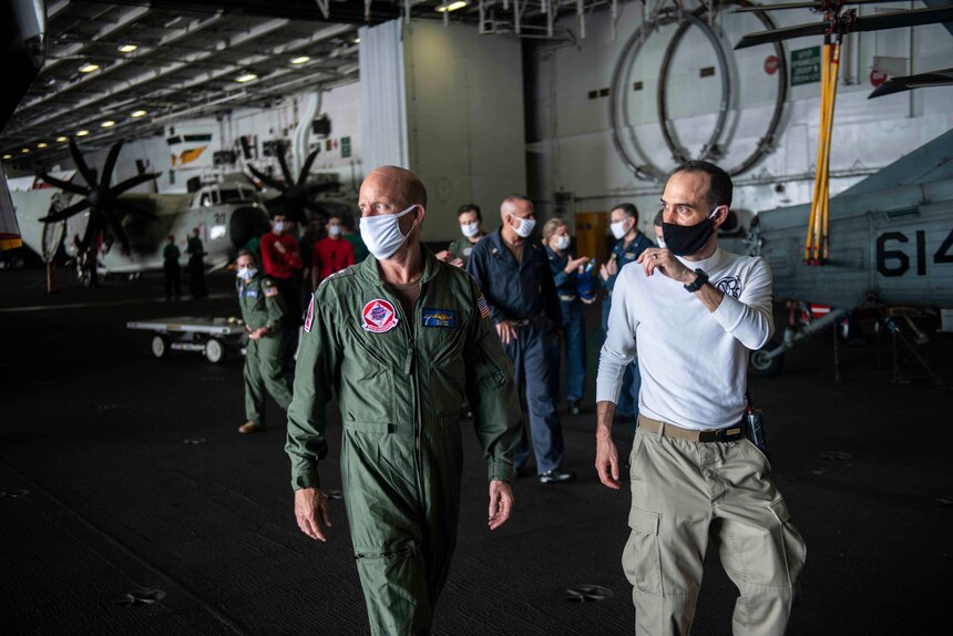 PHILLIPINE SEA (May 30, 2020) Commander, U.S. 7th Fleet, Vice Adm. William R. Merz speaks with Capt. Matthew Ventimiglia, executive officer of the Navy’s forward-deployed aircraft carrier USS Ronald Reagan (CVN 76), in the hangar bay during a scheduled visit. During the visit, Merz talked with Sailors about the health of the force and surveyed the ship’s readiness to support assigned missions. Ronald Reagan, the flagship of Carrier Strike Group 5, provides a combat-ready force that protects and defends the United States, as well as the collective maritime interests of its allies and partners in the Indo-Pacific region.