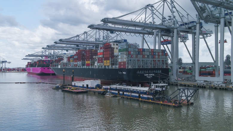 The Dredge Hampton Roads is shown maintaining a deepened channel in front of large cargo vessels docked at the Garden City Terminal of the Georgia Ports Authority, May 28, 2020. Photo by Georgia Ports Authority