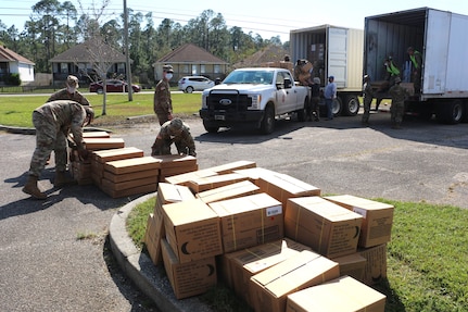 Members of the Mississippi National Guard's 890th Engineer Battalion unload tarps, water, ice, food and other relief supplies in Bay St. Louis, Miss., Oct. 31, 2020. The Soldiers are part of Joint Task Force Zeta, working with the Mississippi Emergency Management Agency to help communities affected by Hurricane Zeta.