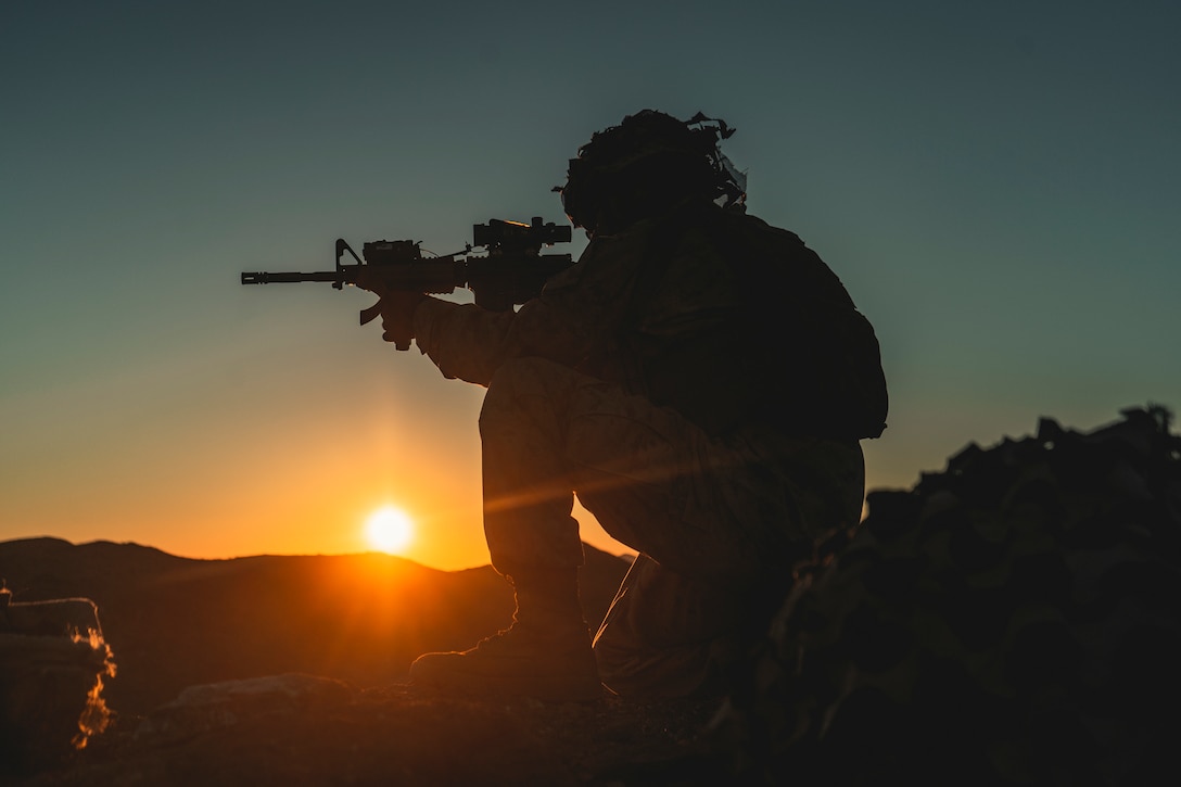 A U.S. Navy corpsman sets into a defensive position in support of the Battalion Distributed Operations Course during Service Level Training Exercise 1-21 at Marine Corps Air Ground Combat Center Twentynine Palms, Calif., Oct. 28.