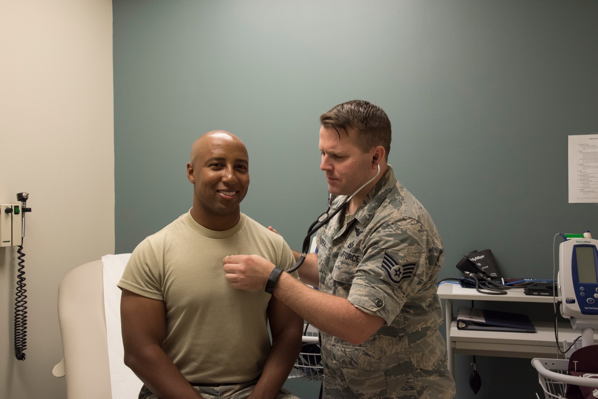 a cardiopulmonary lab technician, checks an Airman’s heart at the 105th Airlift Wing’s medical office