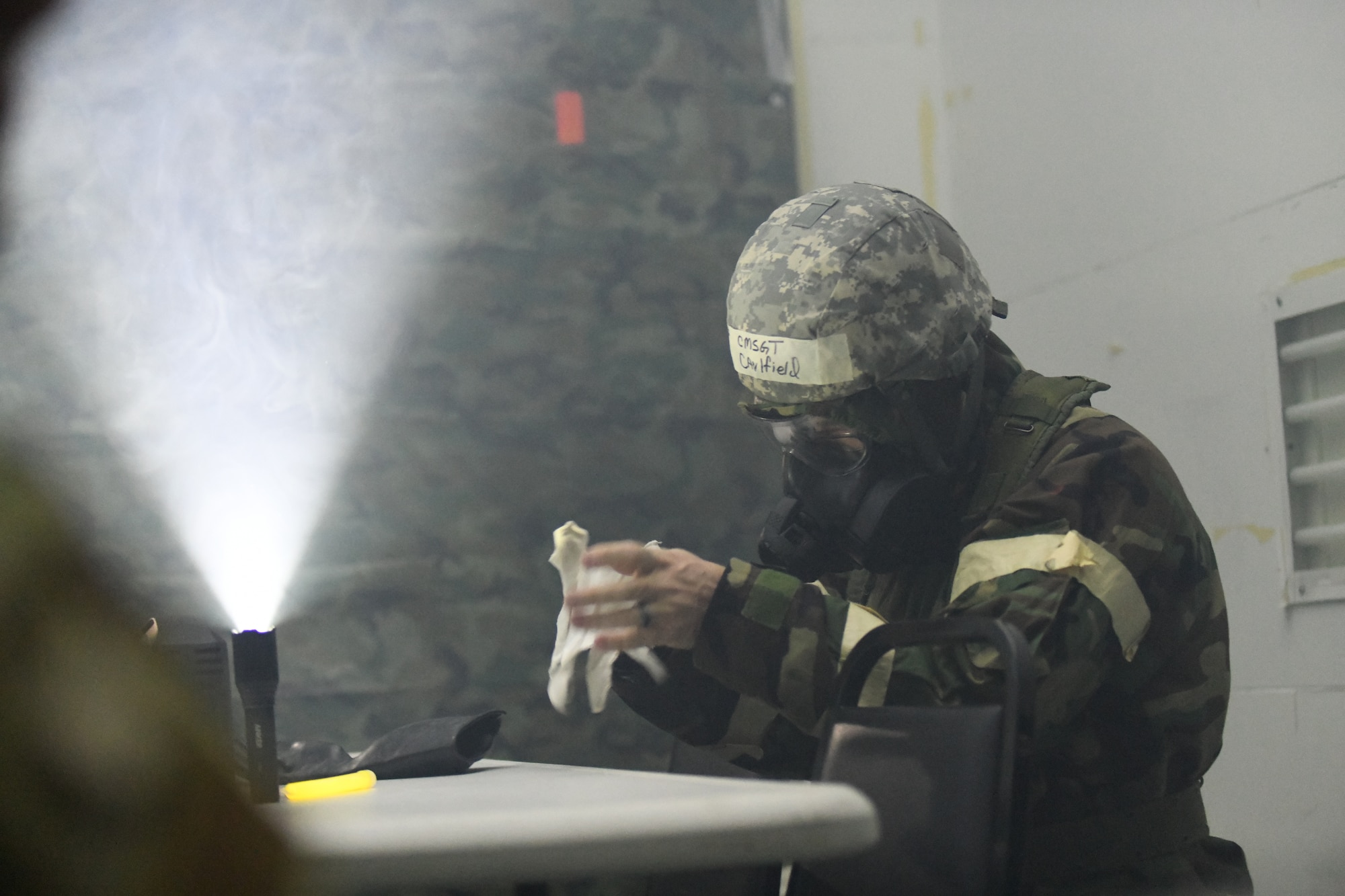 Chief Master Sgt. Joseph Caulfield, 105th AW command chief, prepares for a simulated gas exposure during a joint training, readiness exercise