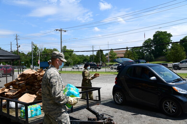 New York Air National Guard Airmen assigned to an Initial Response Force (IRF) from the 105th Airlift Wing based in Newburgh, N.Y. distribute ice and water to Putnam County
