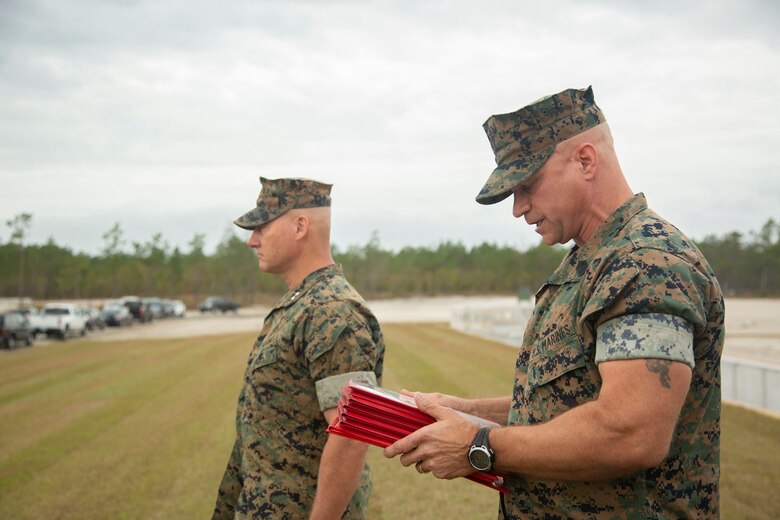 Sgt. Maj. Charles A. Metzger, right, sergeant major of Marine Corps Installations East-Marine Corps Base Camp Lejeune, reads the citation of a Navy and Marine Corps Commendation Medal during an awards ceremony at the site of the new G-36 Company Battle Course Range on MCB Camp Lejeune, North Carolina, Oct. 29, 2020. Marines with 2nd Combat Engineer Battalion and 8th Engineer Support Battalion received the award for their efforts in helping to build the range. The range has been redesigned to enable company commanders to train with organic weapons systems and attachments they would have available during combat and conduct full-scale operations on one range. (U.S. Marine Corps photo by Cpl. Ginnie Lee)
