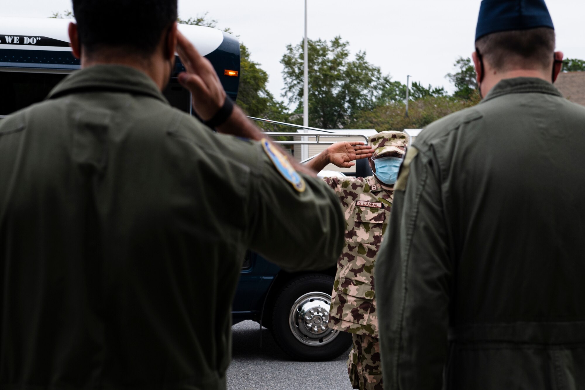 A photo of an Airman saluting other Airmen