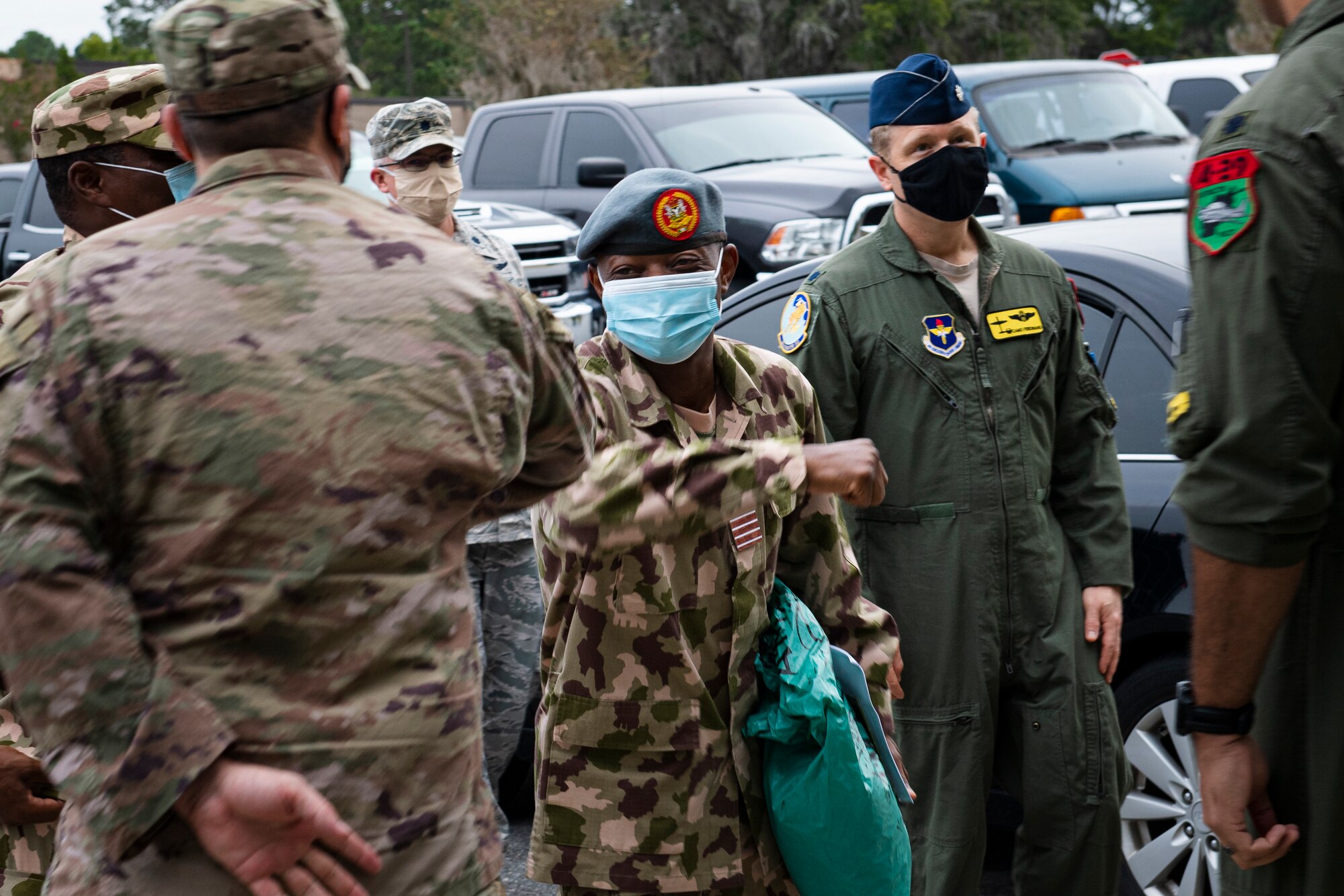 A photo of an Airman greeting other Airmen