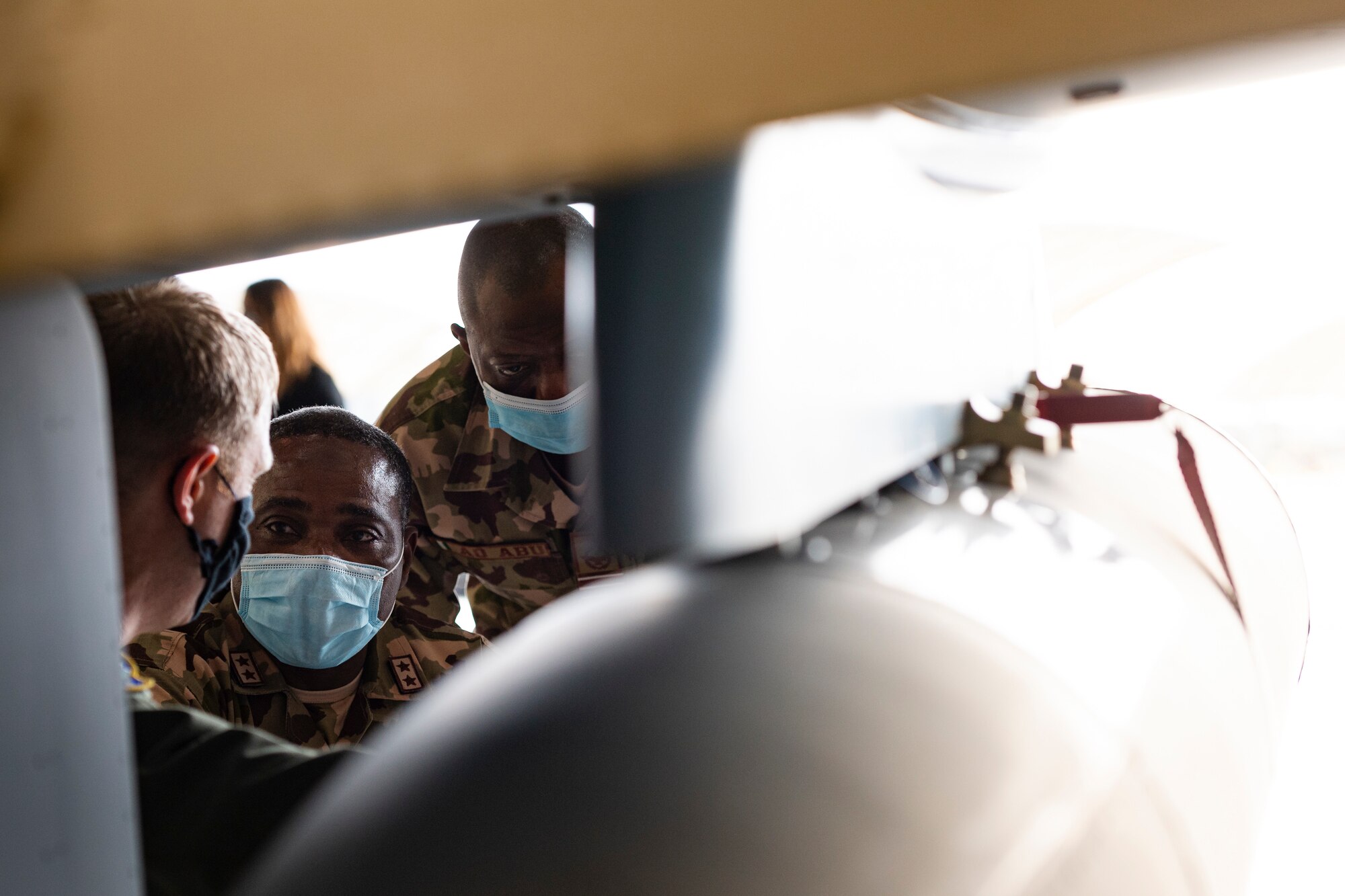 A photo of Airmen looking at an aircraft