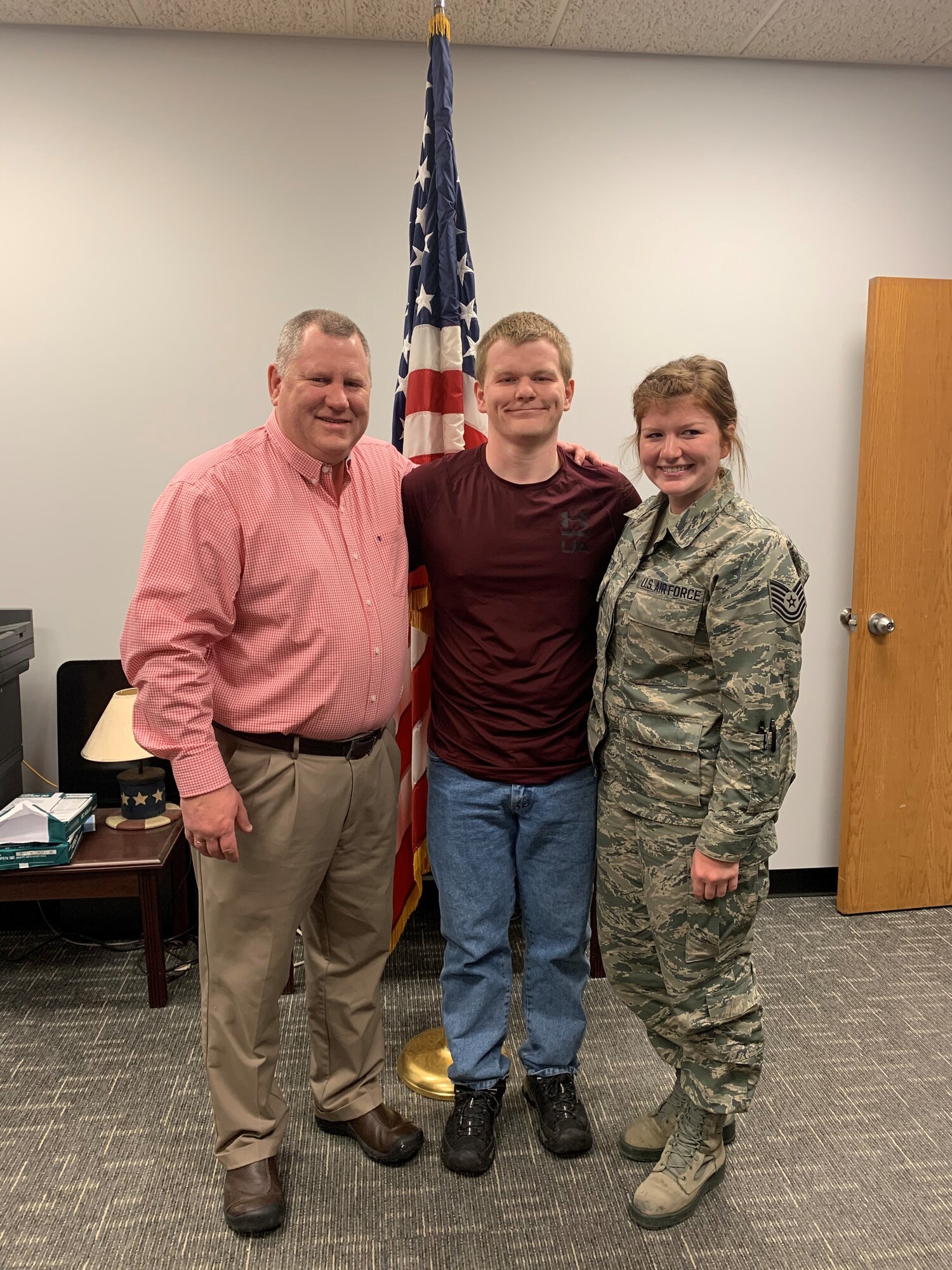 Chief Master Sgt. Kraig Konietzko (ret), Luke Konietzko and Tech. Sgt. Kristianna Konietzko pose for a photo after Luke takes the oath of enlistment at the 148th Fighter Wing in March 2020. (Courtesy Photo)