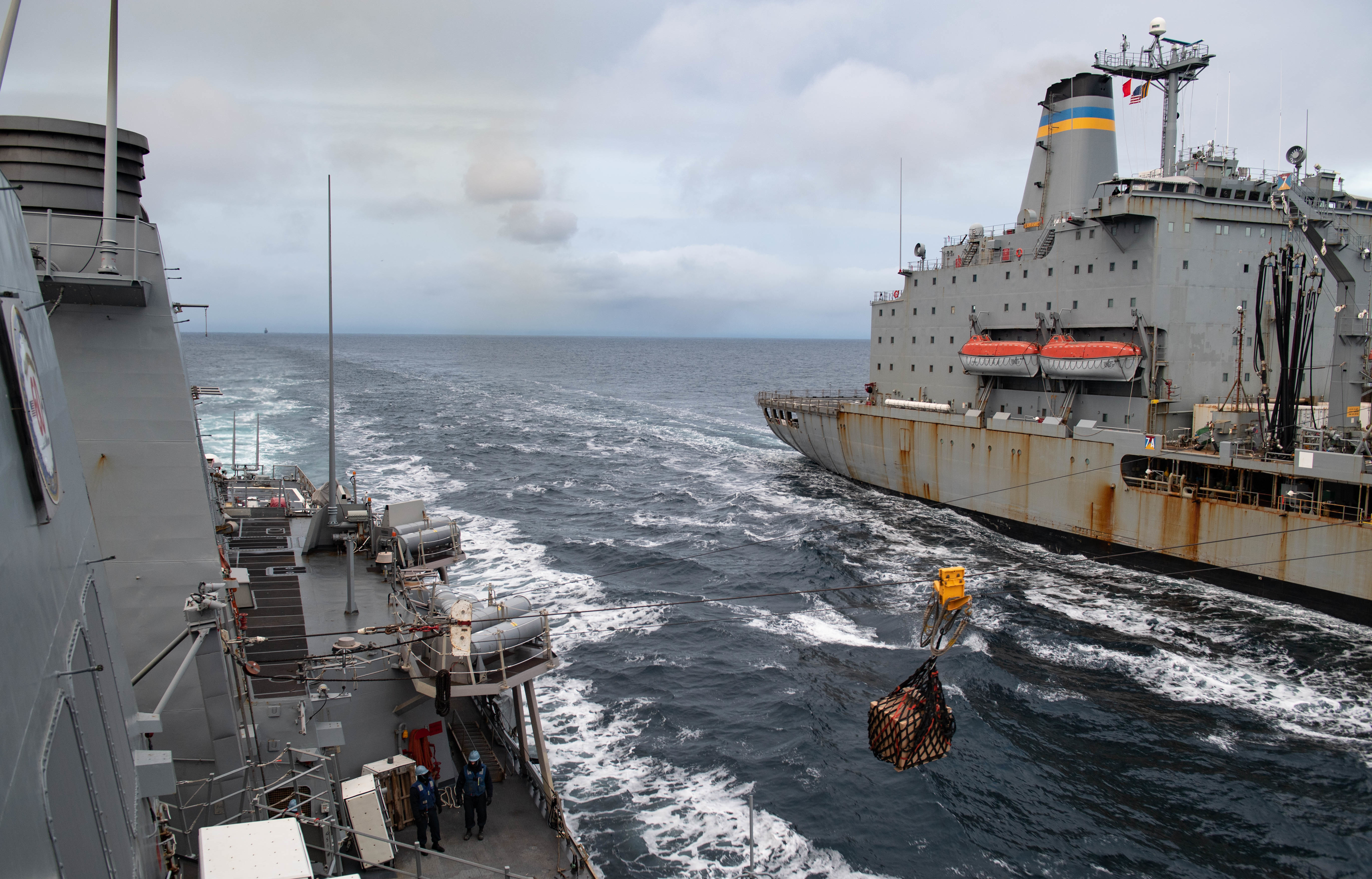 USS Ross (DDG 71) receives stores from USNS Laramie (T-AO-203) during a replenishment-at-sea.