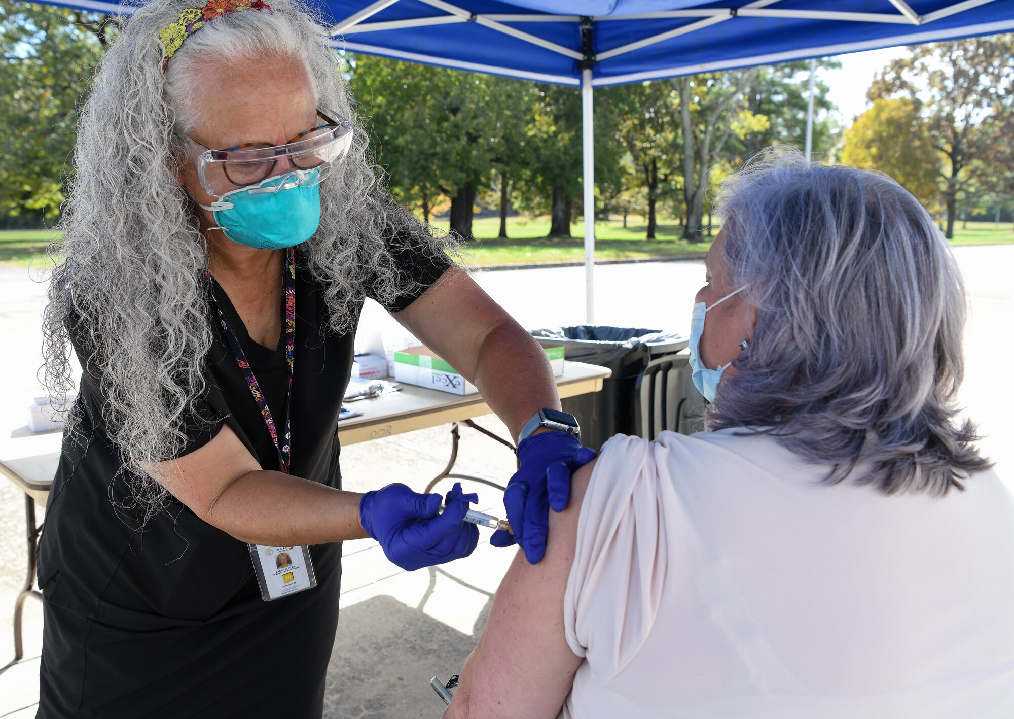 Darla Sain, a registered nurse with the Tennessee Department of Health, administers a flu shot to Peggy Proffitt, an Arnold Engineering Development Complex team member, Oct. 21, 2020, at Arnold Air Force Base, Tenn. The Coffee County Health Department, which operates under the Tenn. Dept. of Health, held the clinic for all who could access the base. The shots were provided free of charge. The Centers for Disease Control and Prevention state it is more important to receive the flu vaccine this year to protect the individual and those around them, and to help reduce strain on healthcare systems during the COVID-19 pandemic. (U.S. Air Force photo by Jill Pickett)