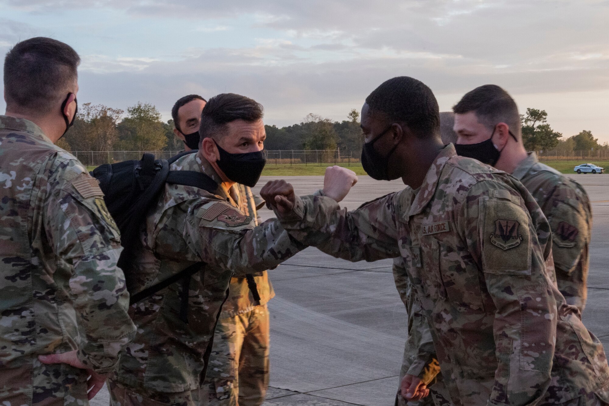 A photo of the 23d Wing command chief elbow bumping an Airman