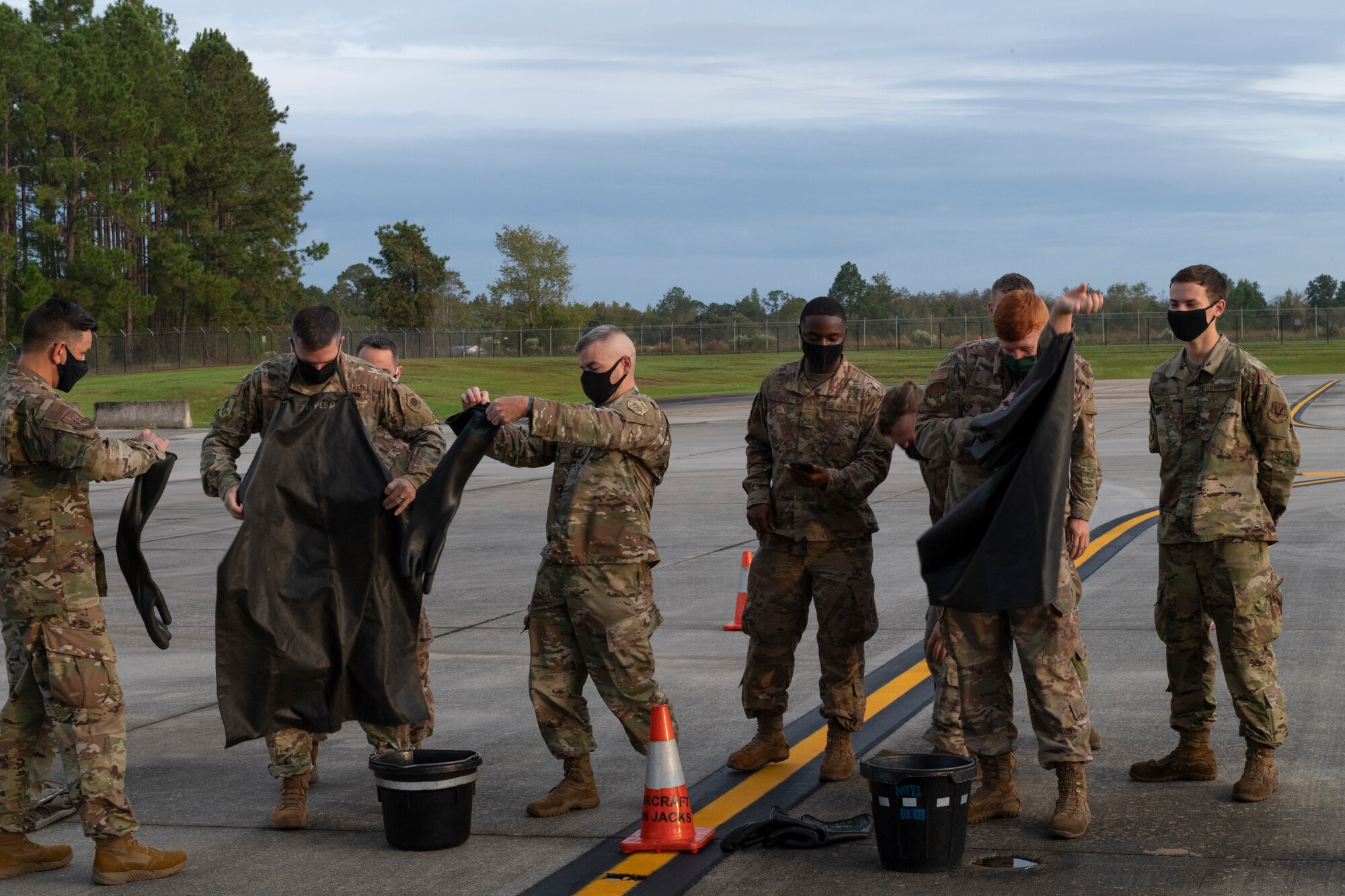 A photo of Airmen donning personal protective equipment