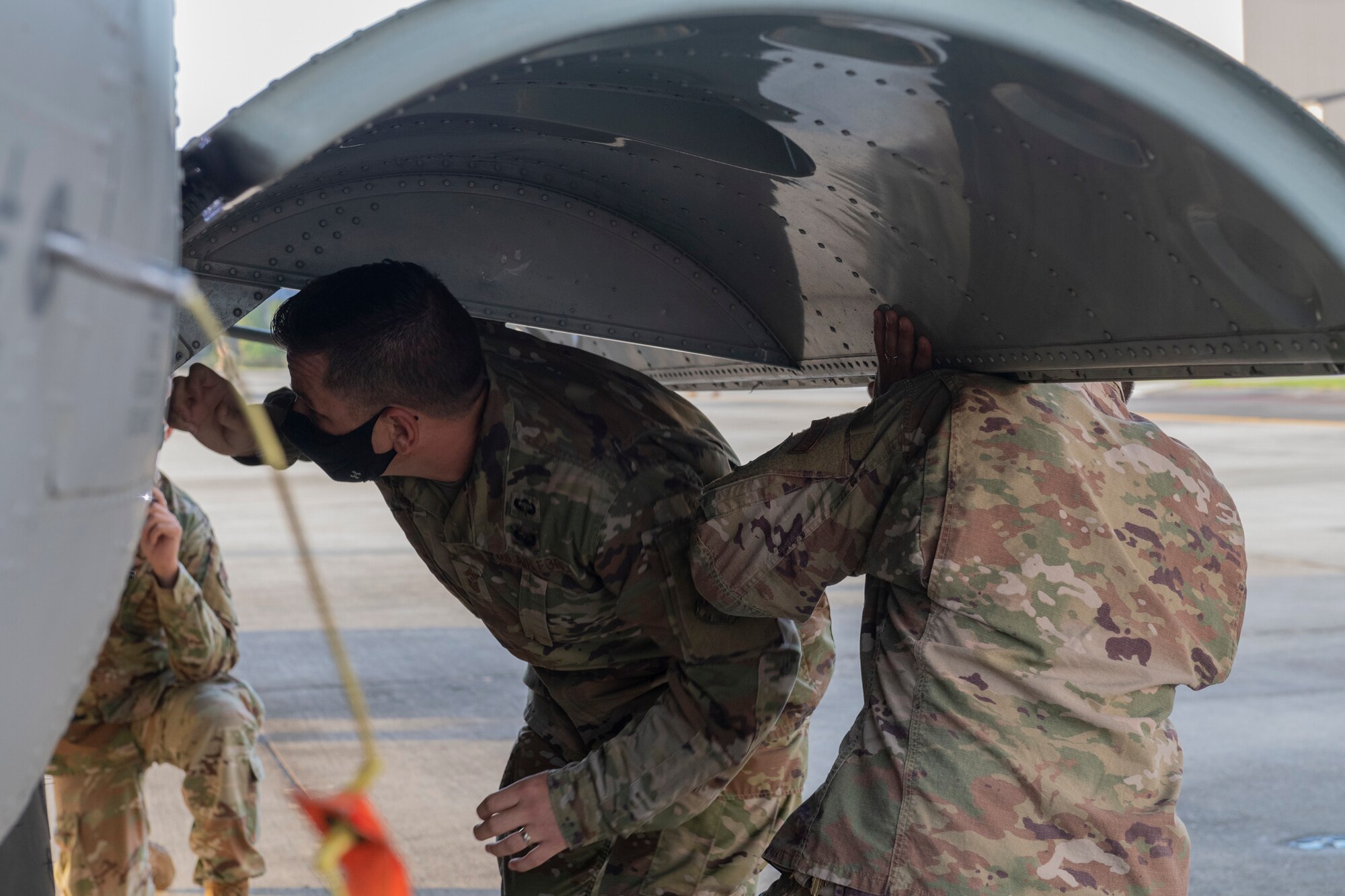 A photo of Airmen connecting rods on a main landing gear door