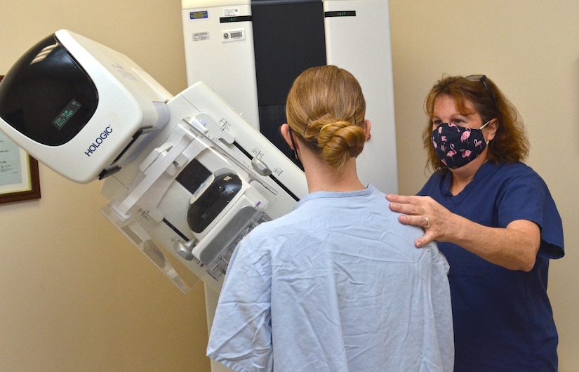 a mammography technologist at Naval Hospital Jacksonville, assists a patient during a mammogram. Kincaid, a native of Allentown, Pennsylvania