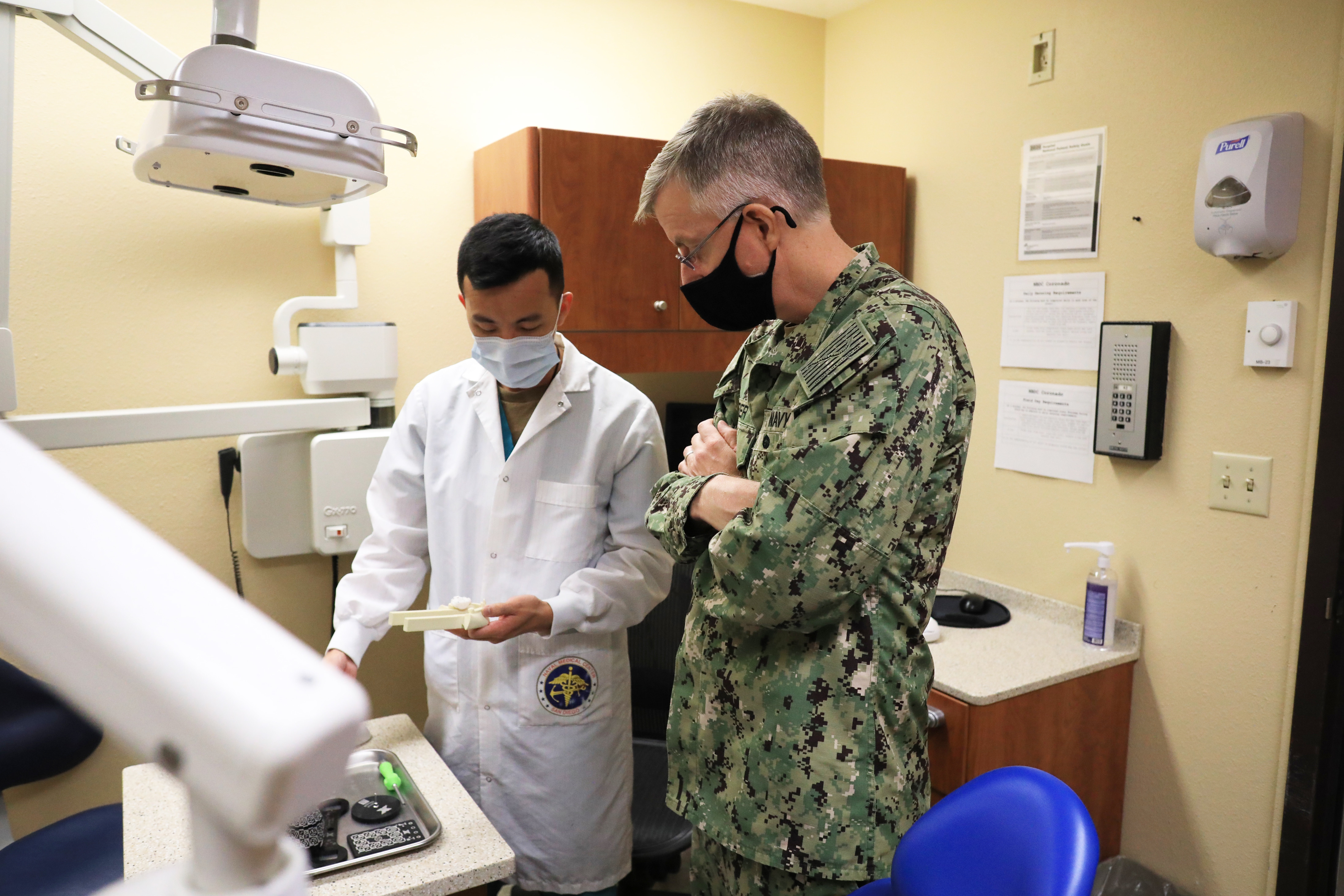Lt. Cmdr. Thien Nguyen, a periodontist at Naval Air Station North Island's dental clinic, talks with Rear Adm. Tim Weber, commander, Naval Medical Forces Pacific (NMFP), during an official visit.