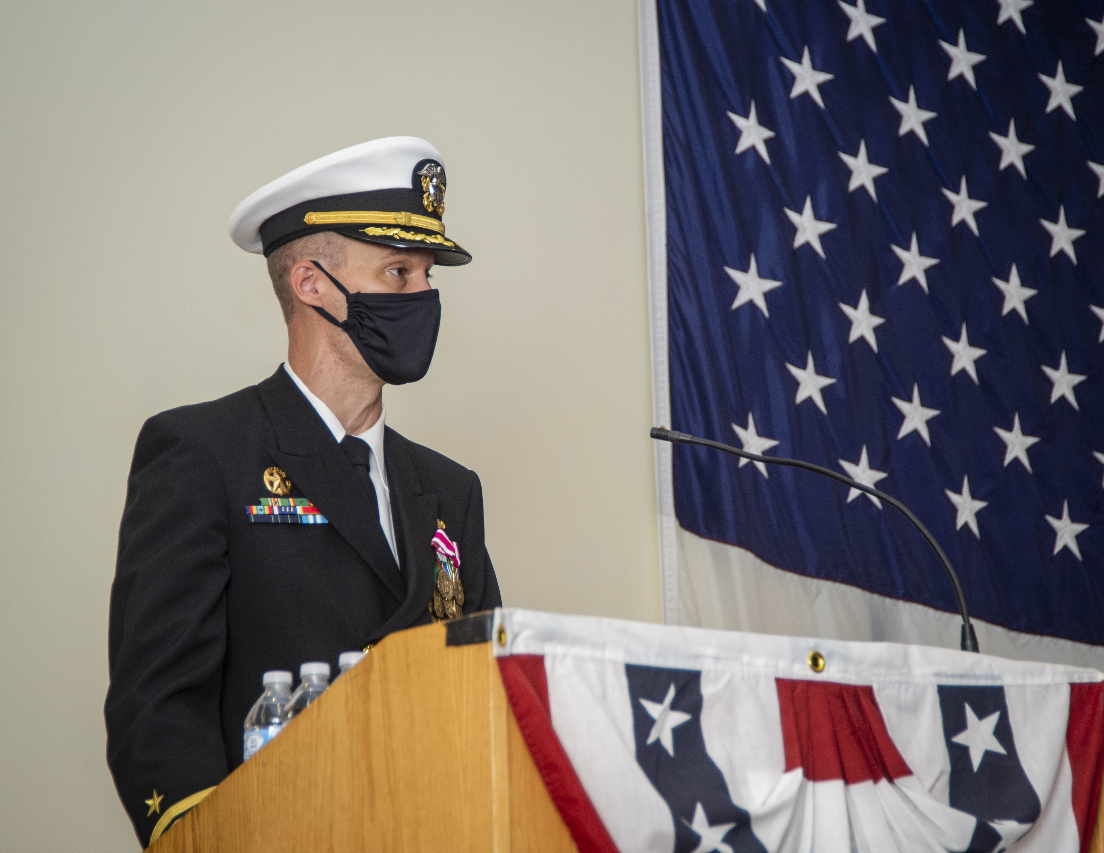 Cmdr. Mathias Vorachek speaks on his time as commanding officer during the Los Angeles-class attack submarine USS Albany (753) change of command ceremony onboard Naval Station Norfolk, Oct. 30, 2020.