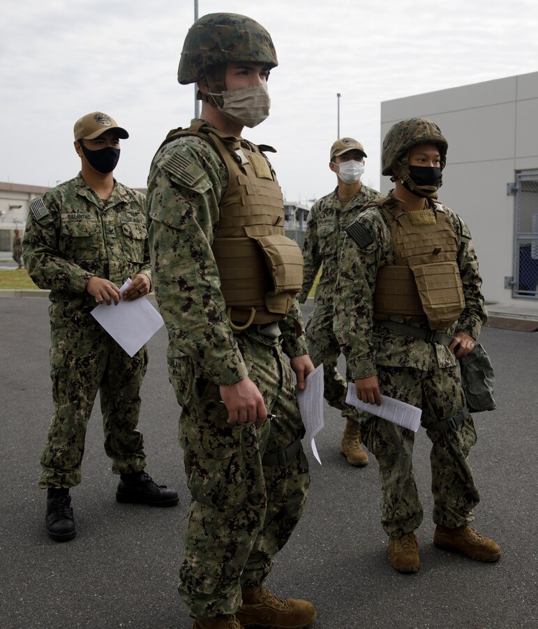 U.S. service members wait in line to receive the influenza vaccine during Exercise Active Shield aboard Marine Corps Air Station (MCAS) Iwakuni, Japan, Oct. 28, 2020. The Naval Family Branch Health Clinic conducted a 72-hour mass immunization event to vaccinate all active-duty service members at the air station. Active Shield is an annual bilateral exercise partnering U.S. and Japanese forces for the protection and defense of MCAS Iwakuni and other assets in the region in order to sustain military operations in support of the U.S. - Japan Alliance. (U.S. Marine Corps photo by Lance Cpl. Triton Lai)