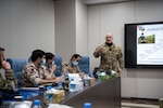 U.S. Air Force Tech. Sgt. Chase Beck, U.S. Air Forces Central Tactical Air Control Party specialist, gives a brief about his career field to Qatar Emiri Air Force members at Al Udied Air Base, Qatar, Oct. 22, 2020.