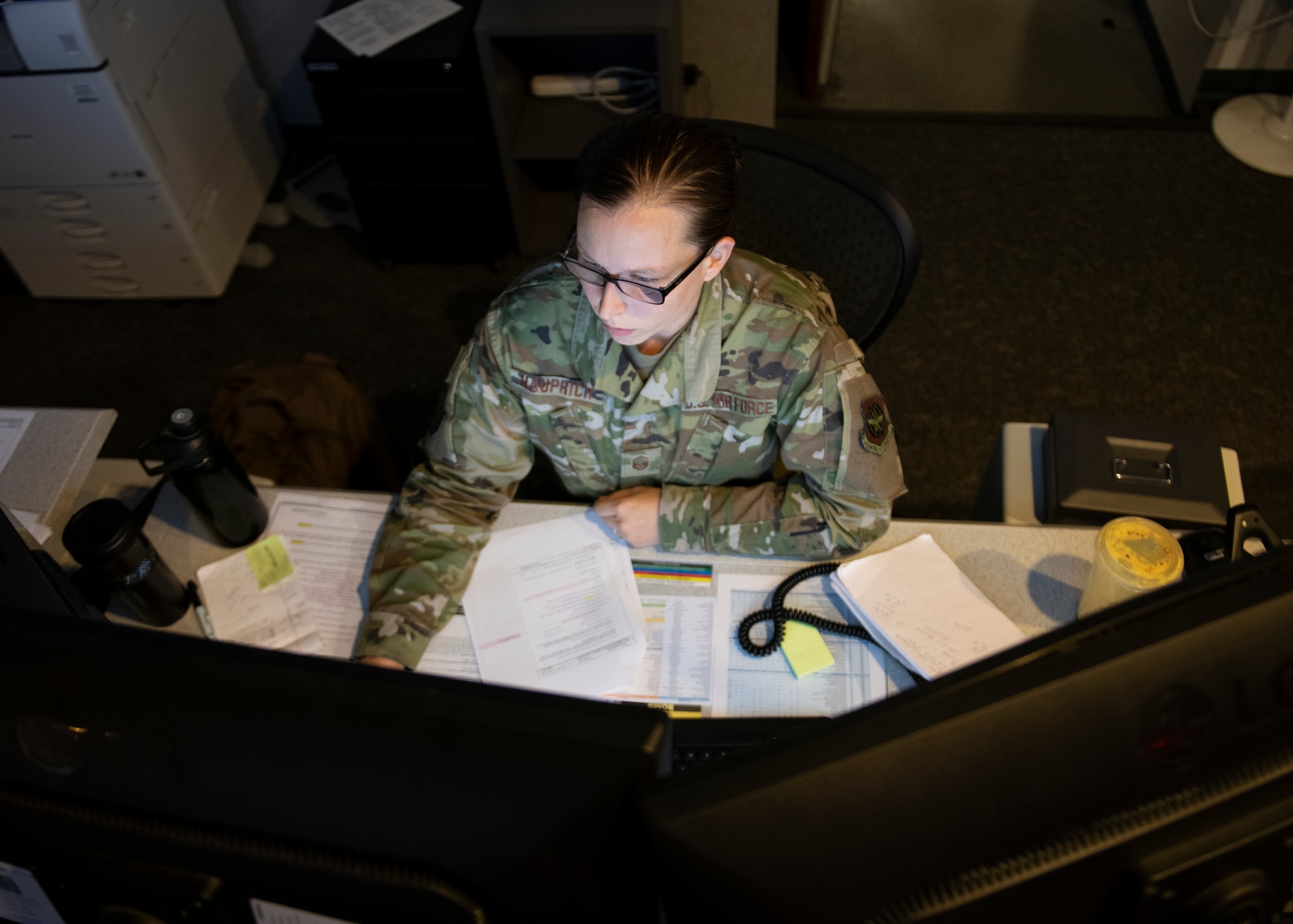 U.S. Air Force Master Sgt. Elizabeth Hauprich, 60th Air Mobility Wing Command Post noncommissioned officer in charge of command and control operations, monitors information on her computer console Sept. 17, 2020, at Travis Air Force Base, California.
