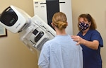 a mammography technologist at Naval Hospital Jacksonville, assists a patient during a mammogram. Kincaid, a native of Allentown, Pennsylvania