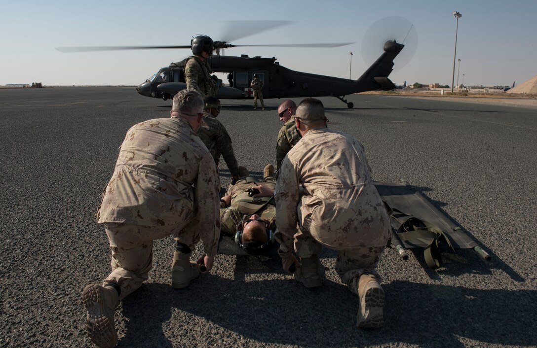 Medical personnel prepare to carry a patient to a UH-60 Black Hawk helicopter for transport during a medical evacuation training exercise at Ali Al Salem Air Base, Kuwait, Oct. 27, 2020.