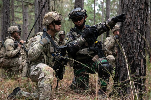 Cpt. Kris Candelaria with Team 513, 5th Security Forces Assistance Brigade, and Indonesian Army 1st Lt. Wilhelmus Raditya, attached to 1st Battalion, 27th Infantry Regiment, 2nd Brigade, 25th Infantry Division, discuss plans for approaching an objective