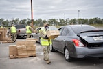 Airmen of the Louisiana Air National Guard's 159th Fighter Wing distribute tarps to citizens following Hurricane Zeta in St. Bernard Parish, Louisiana, Oct. 30, 2020.