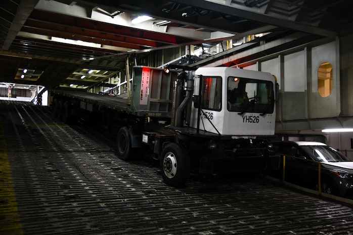 A member from the 841st Transportation Battalion is directed to move a vehicle down a vessel’s ramp at Joint Base Charleston’s Naval Weapons Station, S.C., Oct. 29, 2020. The battalion’s efforts helped support the transport of assets to Southwest Asia. The 841st TB facilitates the onward movement for all eastern seaboard cargo movements.