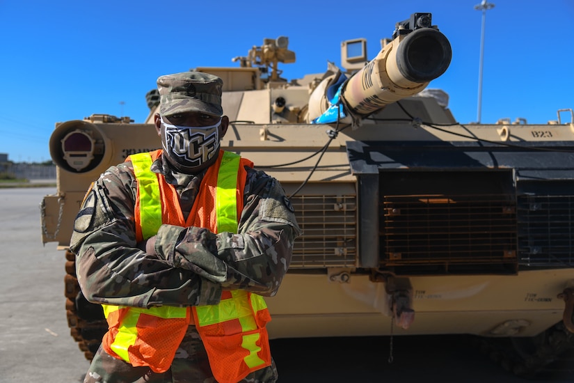 U.S. Army Sgt. 1st Class Ence Spann, a 1189th Transportation Brigade first sergeant, poses for a portrait in front of a tank at Joint Base Charleston’s Naval Weapons Station, S.C., Oct. 30, 2020. The battalion’s efforts helped support the transport of assets to Southwest Asia. The 841st TB facilitates the onward movement for all eastern seaboard cargo movements.