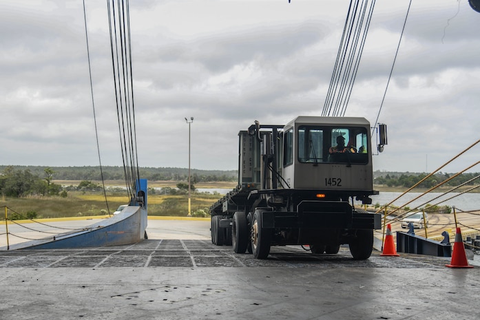 A member assigned to the 841st Transportation Battalion uploads a vehicle onto a vessel at Joint Base Charleston’s Naval Weapons Station, S.C., Oct. 29, 2020. The battalion’s efforts helped support the transport of assets to Southwest Asia. The 841st TB facilitates the onward movement for all eastern seaboard cargo movements.