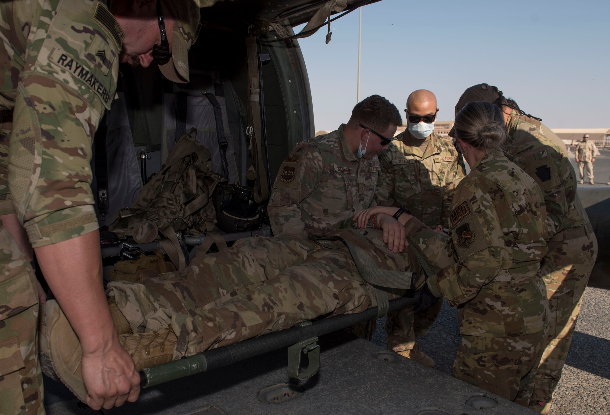 Medical personnel transfer a patient onto a UH-60 Black Hawk helicopter during a medical evacuation training exercise at Ali Al Salem Air Base, Kuwait, Oct. 27, 2020.