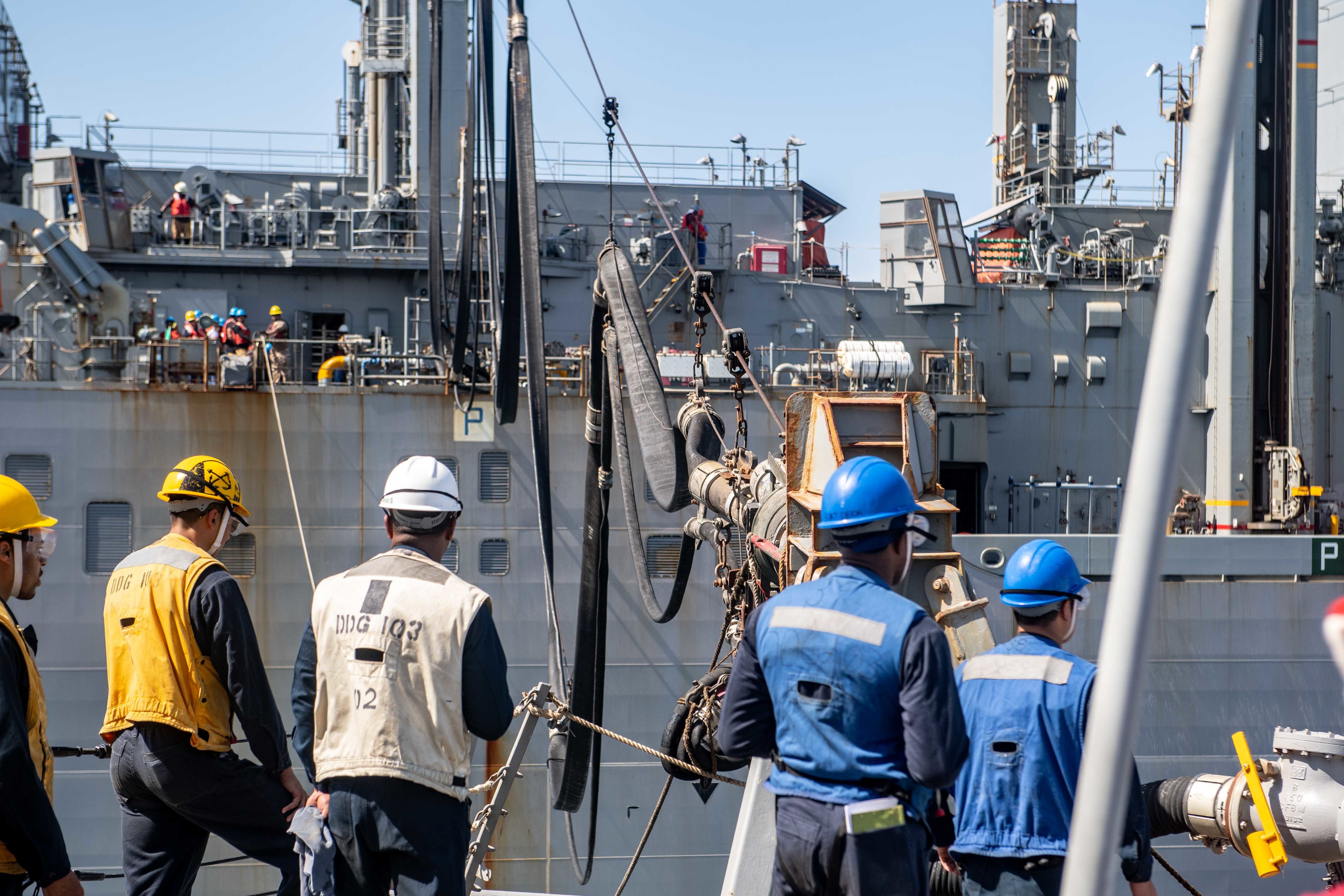 Sailors assigned to the guided-missile destroyer USS Truxtun (DDG 103) conduct a replenishment-at-sea with the dry cargo and ammunition ship USNS Robert E. Peary (T-AKE 5) on March 22, 2020.