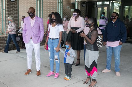 Masked with matching masks that bore her name, McCray’s family was also in attendance as her co-workers gathered around them.