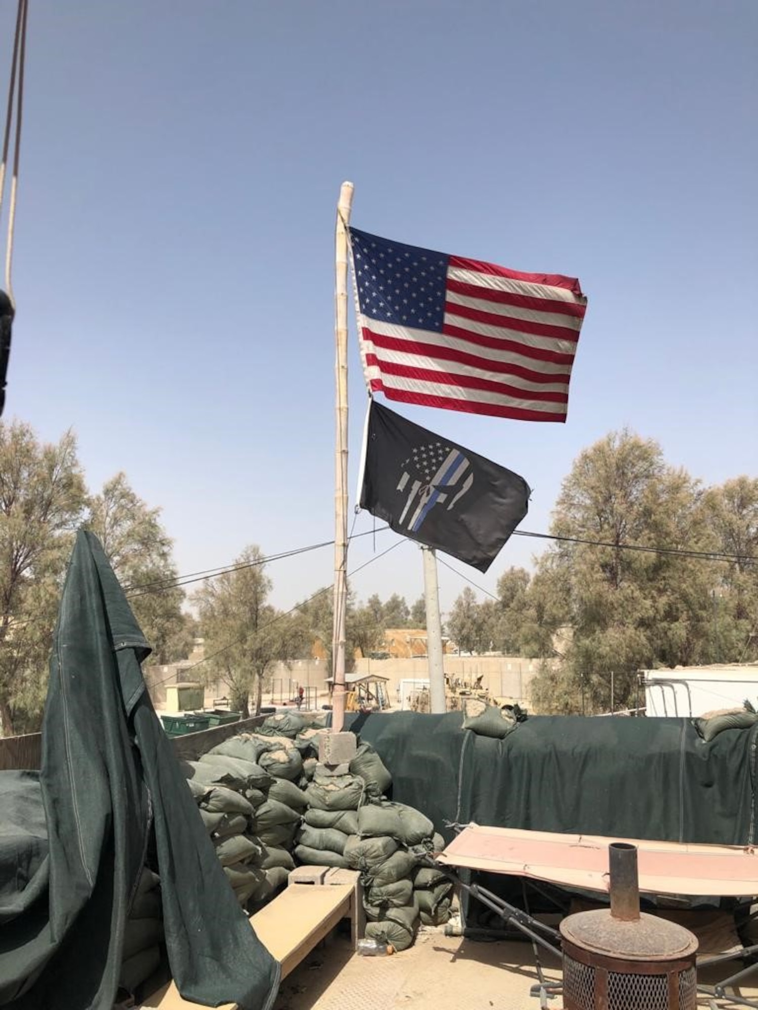 The OSI Expeditionary Detachment 2413, Task Force Black, "Lucky 13" flag waves with Old Glory prior to the unit's End of Mission Oct. 28, 2020. (Photo by SA Carl Hanauer)