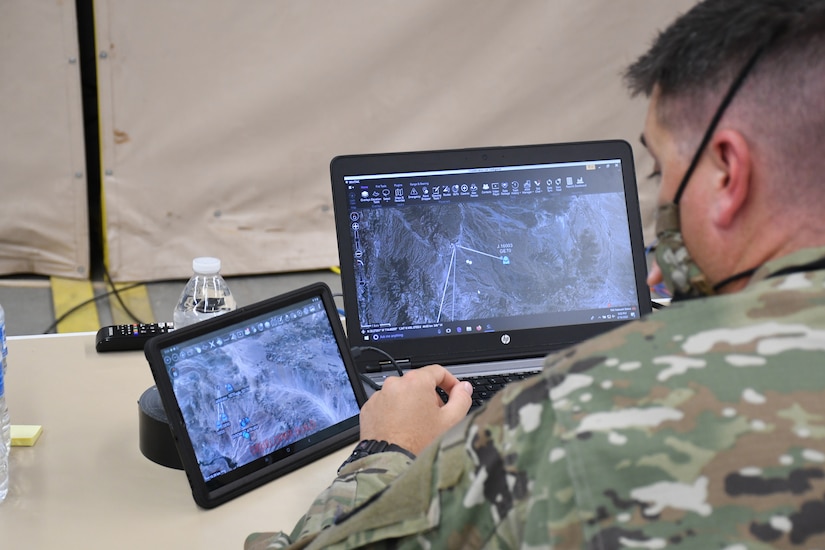 A person monitors computer screens.