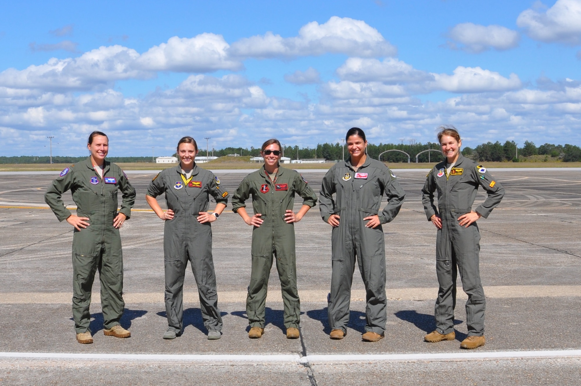five pilots stand on the flight line