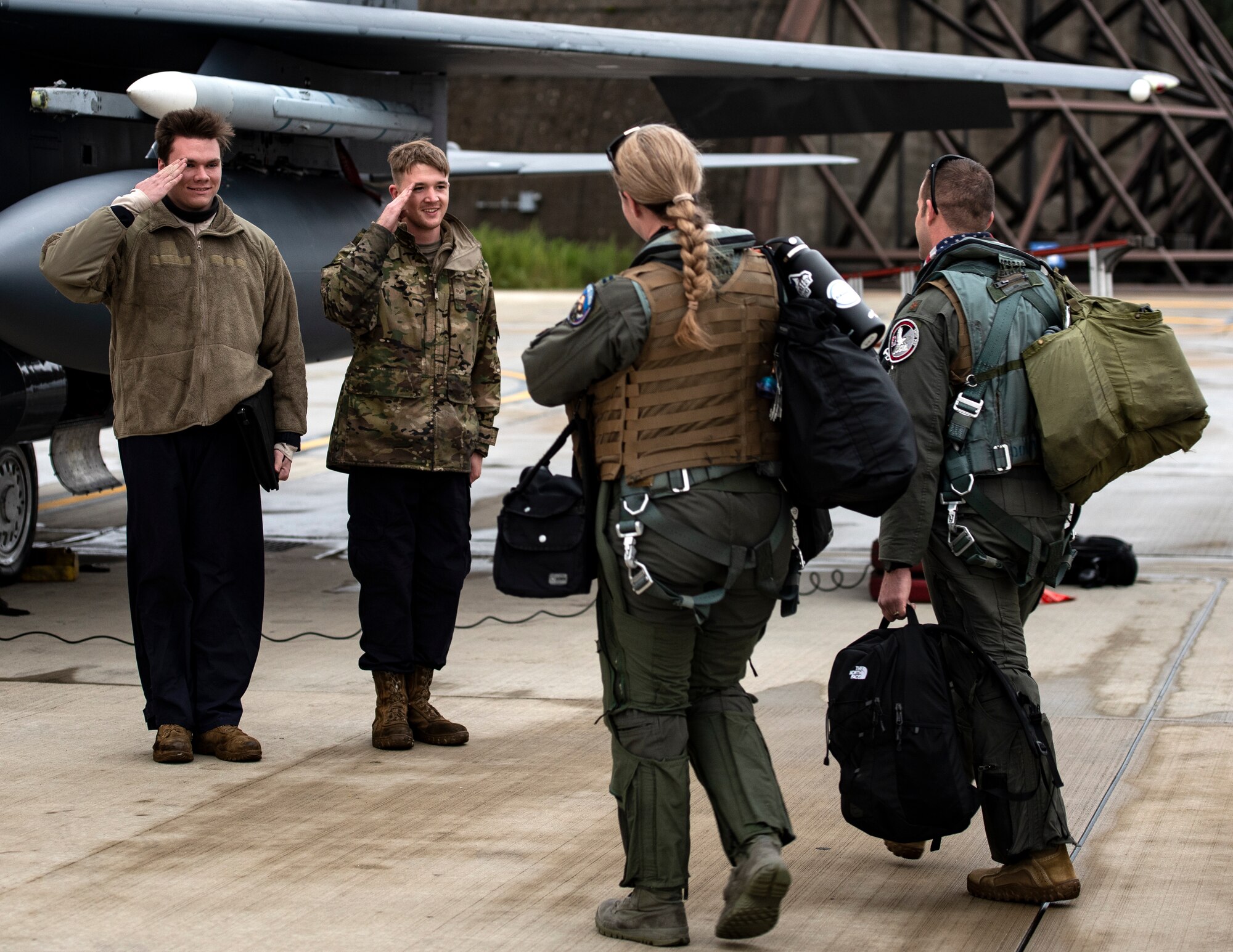 U.S. Air Force Airmen assigned to the 48th Aircraft Maintenance Squadron salute aircrew as they prepare to depart Royal Air Force Lakenheath, England, to Aalborg Air Base, Denmark, Oct. 30, 2020. Agile combat employment within the Baltic airspace and surrounding nations is key to regional defense and stability. Collective training events enhance the ability of NATO forces to work together effectively to fight from varying locations and respond to any threats. (U.S Air Force photo by Airman 1st Class Jessi Monte)