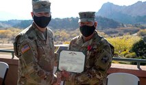 Col. Michael Hatfield, commander of the 100th Missile Defense Brigade, left, presents Command Sgt. Maj. with the Legion of Merit in recognition of his 36-year Army career prior to a change of responsibility ceremony at the Garden of the Gods Visitor and Nature Center in Colorado Springs Oct. 22, 2020. (U.S. Army photo by Staff Sgt. Zachary Sheely)