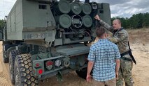 Jason Keep, Army Space Training Division, Home Station Training team, speaks with a Soldier from 18th Field Artillery Brigade, in a live contested environment down range at Fort Bragg, North Carolina, Oct. 27, 2020. (Photo courtesy of Cheryl Hughes/RELEASED)