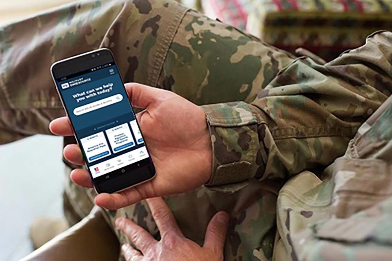 A soldier uses an app on his cellphone.