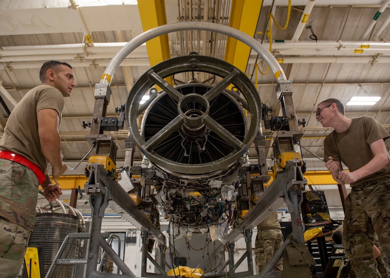 Senior Airman Juan Godoy (left) and Senior Airman Samuel Randlett (right), 4th Component Maintenance Squadron aerospace propulsion journeymen, install the front fan ring onto an F-15E Strike Eagle’s engine at Seymour Johnson Air Force Base, North Carolina, Oct. 28, 2020.