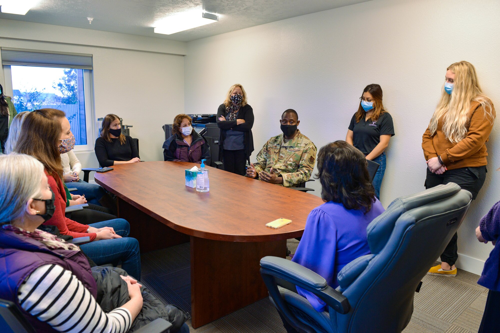 A group of people sit around a table.