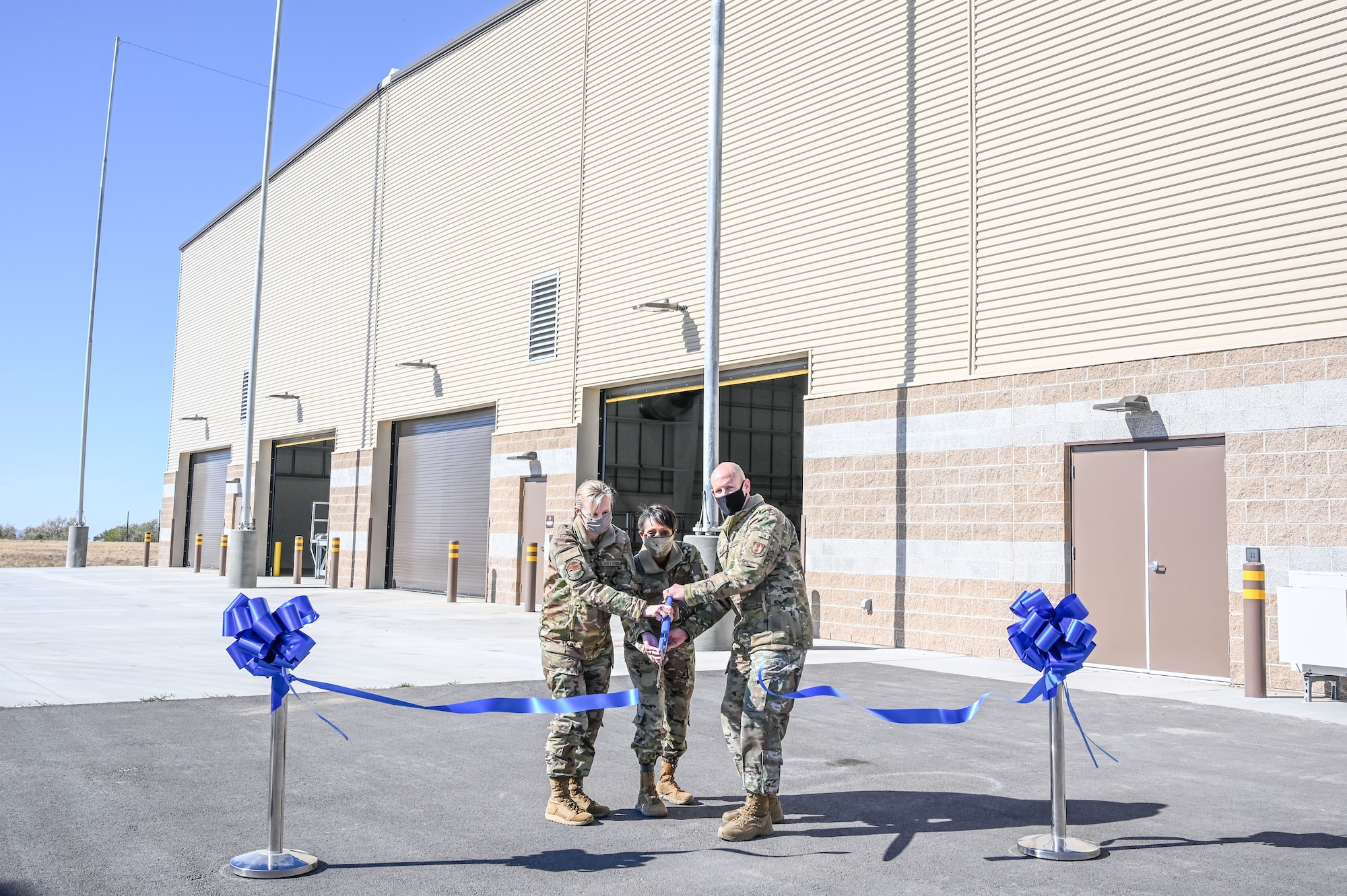 Lt. Col. Naomi Franchetti, 649th Munitions Squadron commander, Col. Jenise Carroll, 75th Air Base Wing commander and Chief Master Sgt. Christopher Walker, 75th ABW command chief, cut the ribbon on 649th MUNS new Standarized Air Munitions Package facility Oct. 22, 2020, at Hill Air Force Base, Utah. (U.S. Air Force photo by Cynthia Griggs)