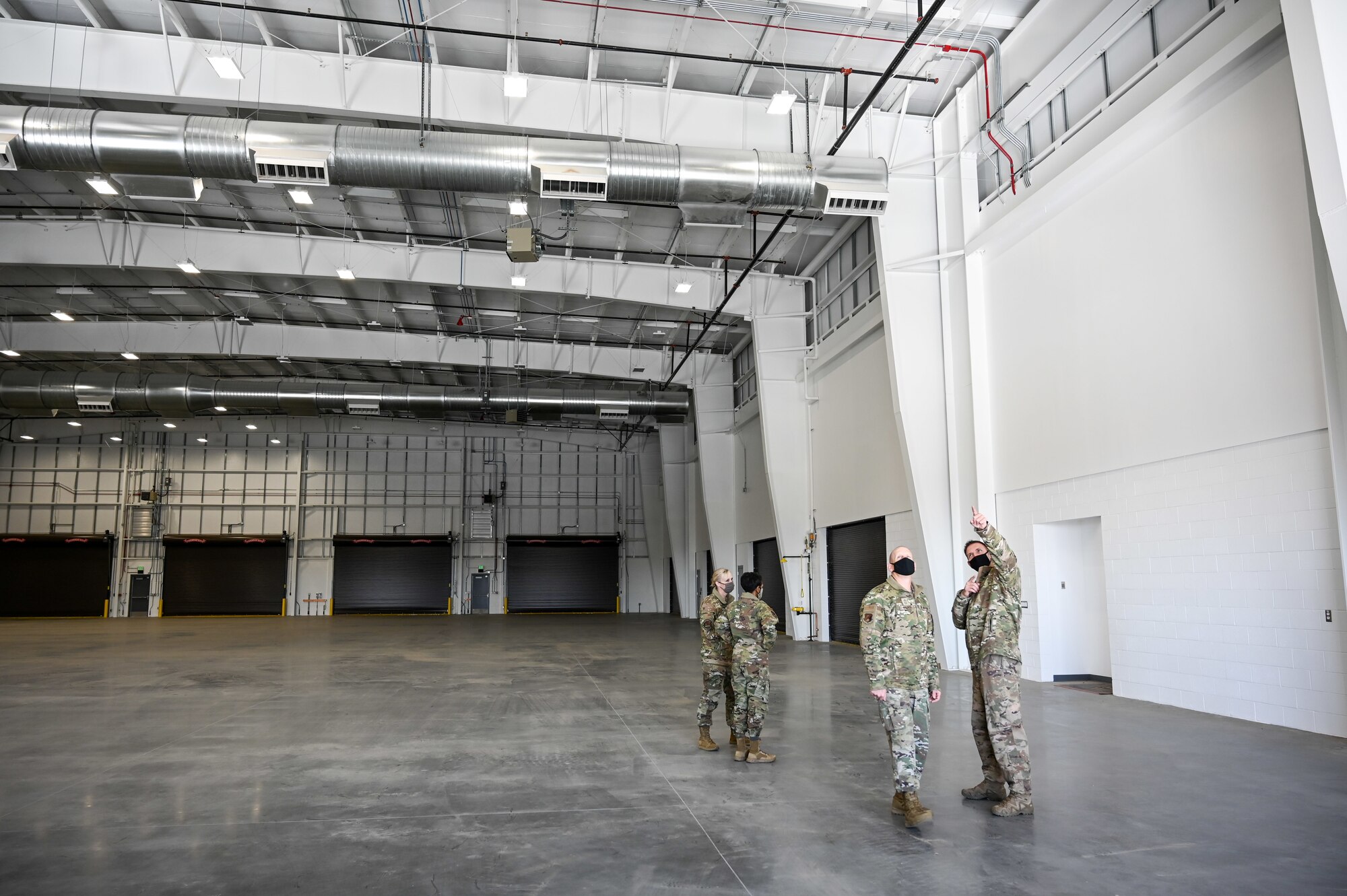 Senior Master Sgt. Dayton Wenzel, 649th Munitions Squadron, walks Chief Master Sgt. Christopher Walker, 75th Air Base Wing command chief, around the new Standarized Air Munitions Package facility Oct. 22, 2020, at Hill Air Force Base, Utah. (U.S. Air Force photo by Cynthia Griggs)