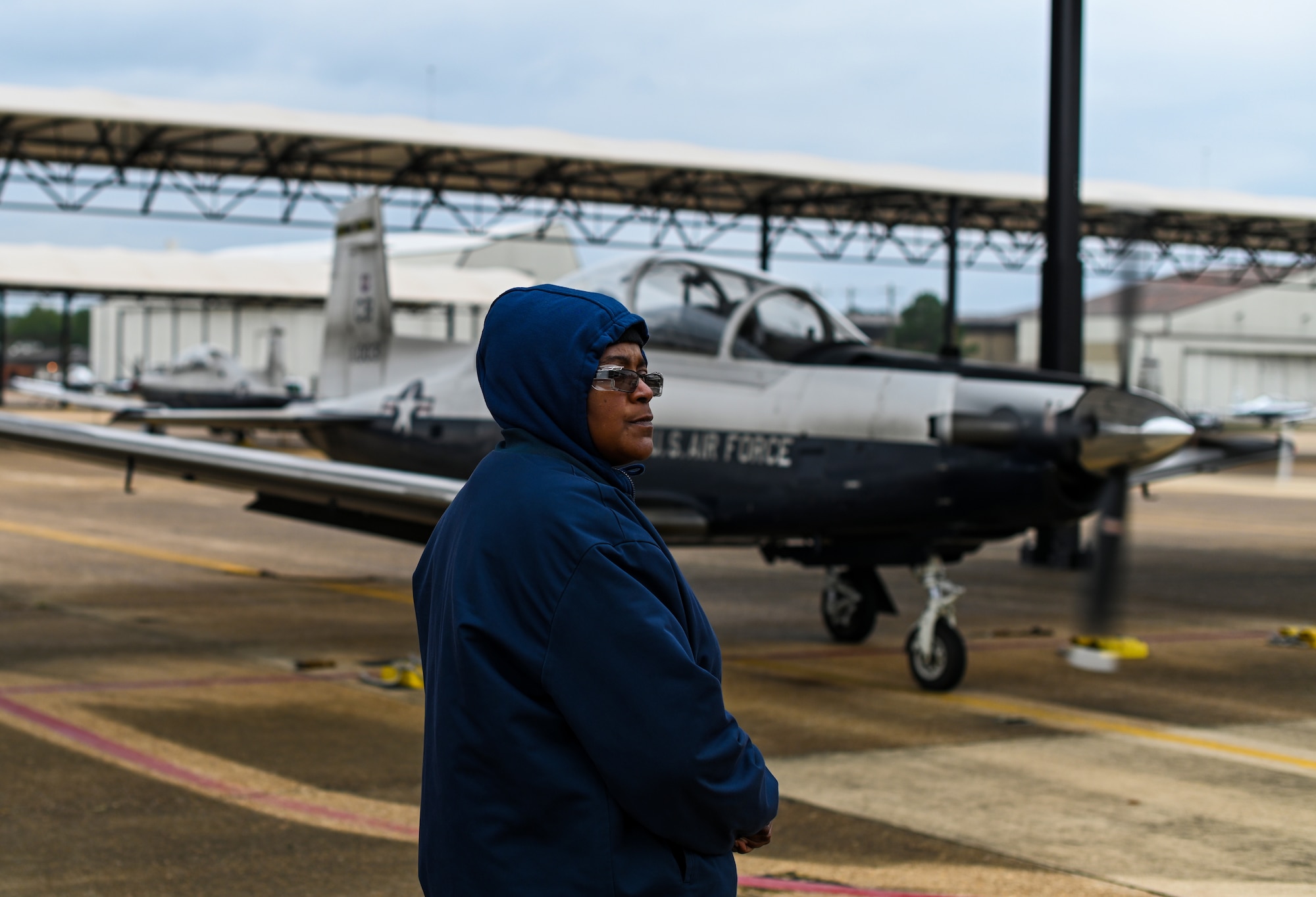 Charlotte Lindsey, M1 Support Services T-6A Texan II maintainer, prepares to guide a T-6 for taxiing on Oct. 30, 2020, at Columbus Air Force Base, Miss. The T-6 is a single-engine, two-seat primary trainer designed to train Joint Primary Pilot Training, or JPPT, students in basic flying skills common to U.S. Air Force and Navy pilots. (U.S. Air Force photo by Airman 1st Class Davis Donaldson)