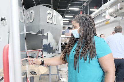 Ashlee Floyd from Naval Surface Warfare Center, Carderock Division works on a SmartBoard to navigate NavalX’s online event calendar portal on Oct 13, 2020.