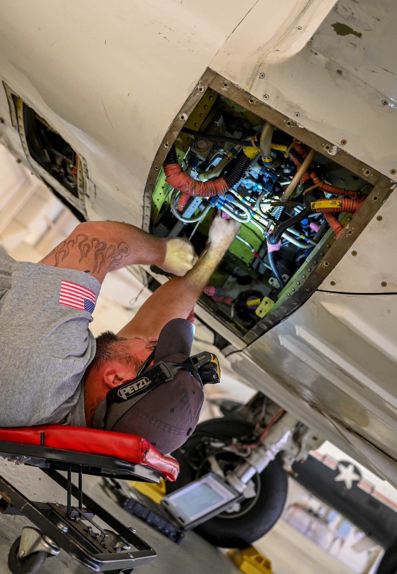 Jason Nesser, M1 Support Services fuel systems lead, inspects the fuel system of a T-6A Texan II on Oct. 29, 2020, at Columbus Air Force Base, Miss. Because of its excellent thrust-to-weight ratio, the T-6 can perform an initial climb of 3,100 feet (944.8 meters) per minute and can reach 18,000 feet (5,486.4 meters) in less than six minutes. (U.S. Air Force photo by Airman 1st Class Davis Donaldson)