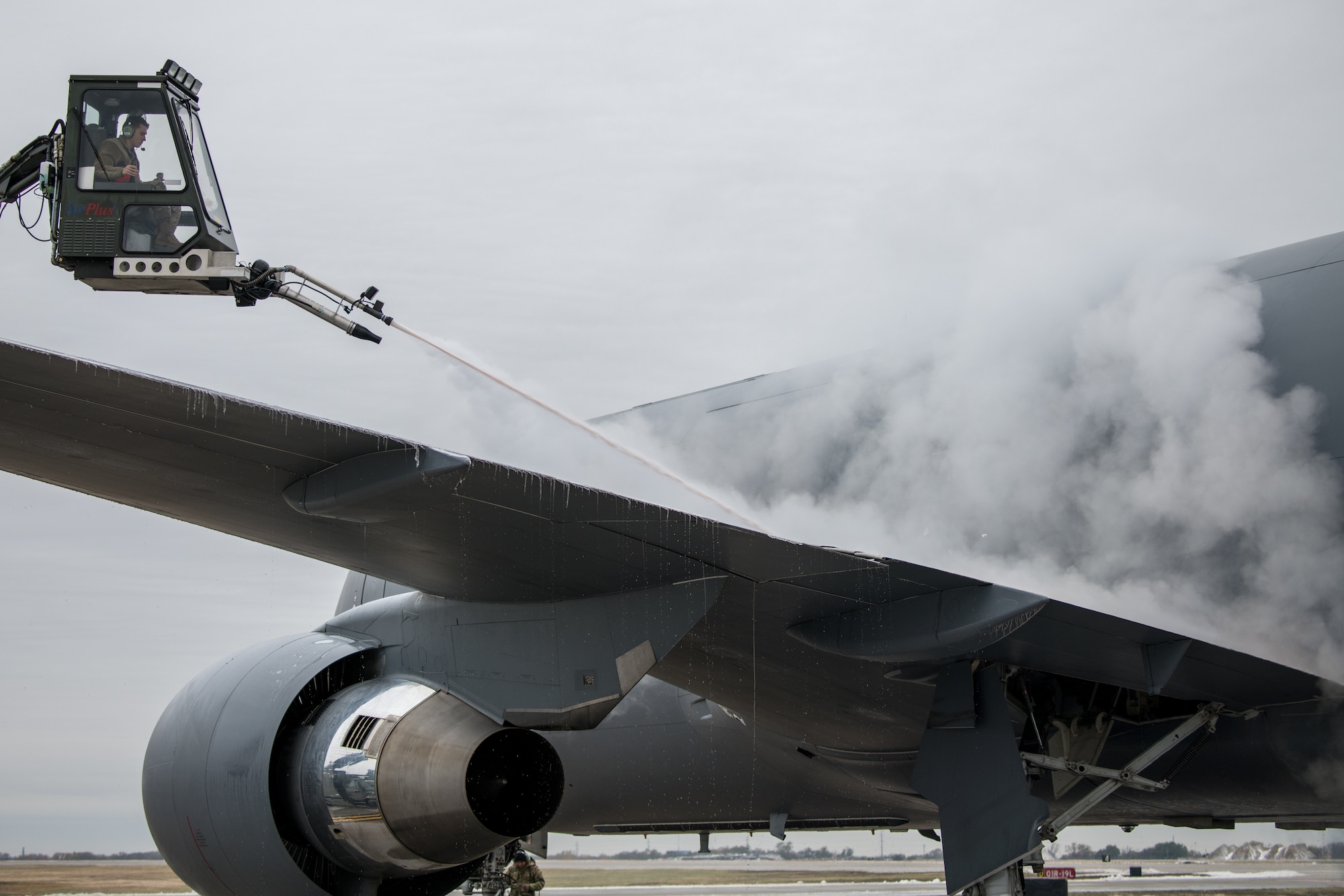 Senior Airman Thomas Hawkins, 22nd Maintenance Squadron aerospace propulsion journeyman, sprays the wing of a KC-46A Pegasus from a Global GL1800 de-ice basket Oct. 28, 2020, at McConnell Air Force Base, Kansas.